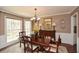 Elegant dining room featuring hardwood floors, a chandelier, and ample natural light for memorable gatherings at 120 Mill Creek Ct, Acworth, GA 30101
