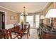 Elegant dining room with hardwood floors, detailed trim, and a large window offering natural light at 120 Mill Creek Ct, Acworth, GA 30101