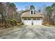 Two-car garage with driveway and lush landscape; a home with curb appeal and convenience at 120 Mill Creek Ct, Acworth, GA 30101
