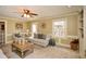 Inviting living room featuring a ceiling fan, neutral decor, and a view to the outdoors at 120 Mill Creek Ct, Acworth, GA 30101