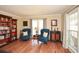 Inviting living room featuring hardwood floors, a large window, and stylish decor, creating a comfortable space at 120 Mill Creek Ct, Acworth, GA 30101