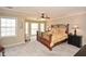 Spacious main bedroom featuring plush carpeting, abundant natural light, and a ceiling fan for added comfort at 120 Mill Creek Ct, Acworth, GA 30101