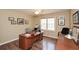 Well-lit home office with wood floors, built-in desk, and ample space for productivity at 120 Mill Creek Ct, Acworth, GA 30101