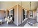 Inviting front porch with swing and white wicker chairs, perfect for relaxing outdoors at 120 Mill Creek Ct, Acworth, GA 30101