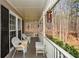 Charming covered porch with swing, seating, and peaceful wooded views at 120 Mill Creek Ct, Acworth, GA 30101