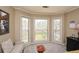 Bright sitting area with large windows offering a scenic view of the wooded backyard at 120 Mill Creek Ct, Acworth, GA 30101