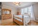 Bedroom with hardwood floors, large window, and ample storage with wooden furniture at 1765 Dew Pl, Marietta, GA 30064