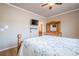 Bedroom with a bed, mounted TV, closet, hardwood floors, and a view into the bathroom at 1765 Dew Pl, Marietta, GA 30064