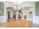 Elegant dining room featuring hardwood floors, wainscoting, archways and chandelier at 1765 Dew Pl, Marietta, GA 30064
