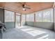 Enclosed sunroom with tiled floor, ceiling fan, and lots of natural light at 1765 Dew Pl, Marietta, GA 30064