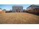 Spacious backyard with lush green grass, a covered patio, and a wooden fence at 3469 English Elm Way, Loganville, GA 30052