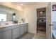 Bright bathroom with double sinks, a large mirror, and an entryway to a bedroom at 3469 English Elm Way, Loganville, GA 30052