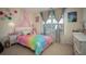 Colorful bedroom with a canopy bed, playful decorations, and lots of natural light at 3469 English Elm Way, Loganville, GA 30052