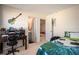Well-lit bedroom with a desk, decorative guitar, and a view into the adjacent bathroom at 3469 English Elm Way, Loganville, GA 30052
