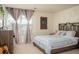 Cozy bedroom with a large window, decorative wall hangings, and modern furnishings at 3469 English Elm Way, Loganville, GA 30052