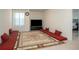 Inviting bonus room featuring carpet flooring, a flat screen tv, and a decorative area rug at 3469 English Elm Way, Loganville, GA 30052