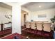 Elegant dining room featuring a spacious table with seating for eight, adorned with stylish decor and ample natural light at 3469 English Elm Way, Loganville, GA 30052