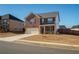Two-story brick home with a two-car garage, complemented by a neatly maintained lawn and inviting curb appeal at 3469 English Elm Way, Loganville, GA 30052