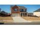 Charming two-story brick home, featuring a two-car garage and a neatly landscaped front yard, perfect for families at 3469 English Elm Way, Loganville, GA 30052