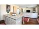 Modern kitchen island featuring granite countertops, with an open view of the living room at 3469 English Elm Way, Loganville, GA 30052