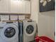Functional laundry area with modern appliances, upper cabinets, and lots of storage space at 3469 English Elm Way, Loganville, GA 30052