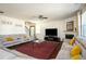 Spacious living room with comfortable sectional sofa, large TV, fireplace and open staircase at 3469 English Elm Way, Loganville, GA 30052