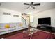 Inviting living room featuring a large TV, staircase, comfortable sectional sofa, and stylish decor at 3469 English Elm Way, Loganville, GA 30052