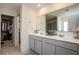 Beautifully updated main bathroom with dual sinks, vanity storage, and a glass enclosed shower at 3469 English Elm Way, Loganville, GA 30052