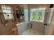 Elegant bathroom features a shower with tiled walls, a window and a neutral color palette at 705 Mill Creek Rdg, Woodstock, GA 30188