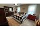 Spacious bedroom with large bed, neutral walls, a ceiling fan, and lots of natural light at 705 Mill Creek Rdg, Woodstock, GA 30188