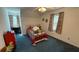 Cozy bedroom with blue carpet, ceiling fan, and windows with decorative curtains at 705 Mill Creek Rdg, Woodstock, GA 30188