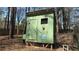 An exterior view of a backyard chicken coop with a secure enclosure at 705 Mill Creek Rdg, Woodstock, GA 30188