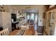 Open kitchen and breakfast area features white cabinets, granite countertops, and hardwood flooring at 705 Mill Creek Rdg, Woodstock, GA 30188