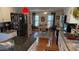 Charming kitchen with island, granite countertops, stainless steel appliances, and hardwood floors at 705 Mill Creek Rdg, Woodstock, GA 30188