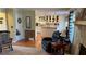Cozy living room showcases fireplace, open flow to kitchen, and hardwood floors at 705 Mill Creek Rdg, Woodstock, GA 30188