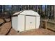 Exterior shot of a metal storage shed with a door and fenced yard at 705 Mill Creek Rdg, Woodstock, GA 30188
