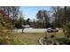 Street view featuring a driveway and lawn with various trees and vegetation at 705 Mill Creek Rdg, Woodstock, GA 30188