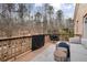 Comfortable seating on the back deck offers serene views of the wooded surroundings at 1525 Camden Cove Dr, Cumming, GA 30040