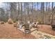 Secluded backyard firepit is surrounded by natural landscaping, perfect for entertaining at 1525 Camden Cove Dr, Cumming, GA 30040