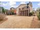 Exterior view of backyard featuring a covered porch and patio, with mature trees at 1525 Camden Cove Dr, Cumming, GA 30040