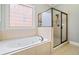Bathroom boasts a soaking tub, and a glass enclosed shower with neutral tile at 1525 Camden Cove Dr, Cumming, GA 30040