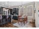 The kitchen and dining area showcase a seamless design with dark cabinets and hardwood floors at 1525 Camden Cove Dr, Cumming, GA 30040