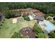 Aerial view of the community's outdoor amenities, including tennis courts, pools, playground, and green spaces at 303 Valley Green Ct, Woodstock, GA 30189