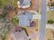 Aerial view of a home showcasing the roof, driveway, landscaping, and the surrounding neighborhood at 303 Valley Green Ct, Woodstock, GA 30189