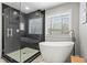 This bathroom boasts a glass enclosed shower and a luxurious soaking tub at 303 Valley Green Ct, Woodstock, GA 30189