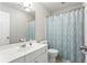 Bathroom featuring single sink vanity, patterned shower curtain, toilet, and white door at 303 Valley Green Ct, Woodstock, GA 30189