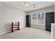 Neutral bedroom featuring light-colored walls, shelving and a window at 303 Valley Green Ct, Woodstock, GA 30189
