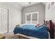 Cozy bedroom with a large window offering natural light and a ceiling fan at 303 Valley Green Ct, Woodstock, GA 30189