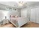 Cozy bedroom with a queen bed, neutral color scheme, natural light, and closet storage at 303 Valley Green Ct, Woodstock, GA 30189