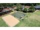Beautiful tennis courts, basketball court, and sand volleyball court surrounded by trees and manicured lawns at 303 Valley Green Ct, Woodstock, GA 30189